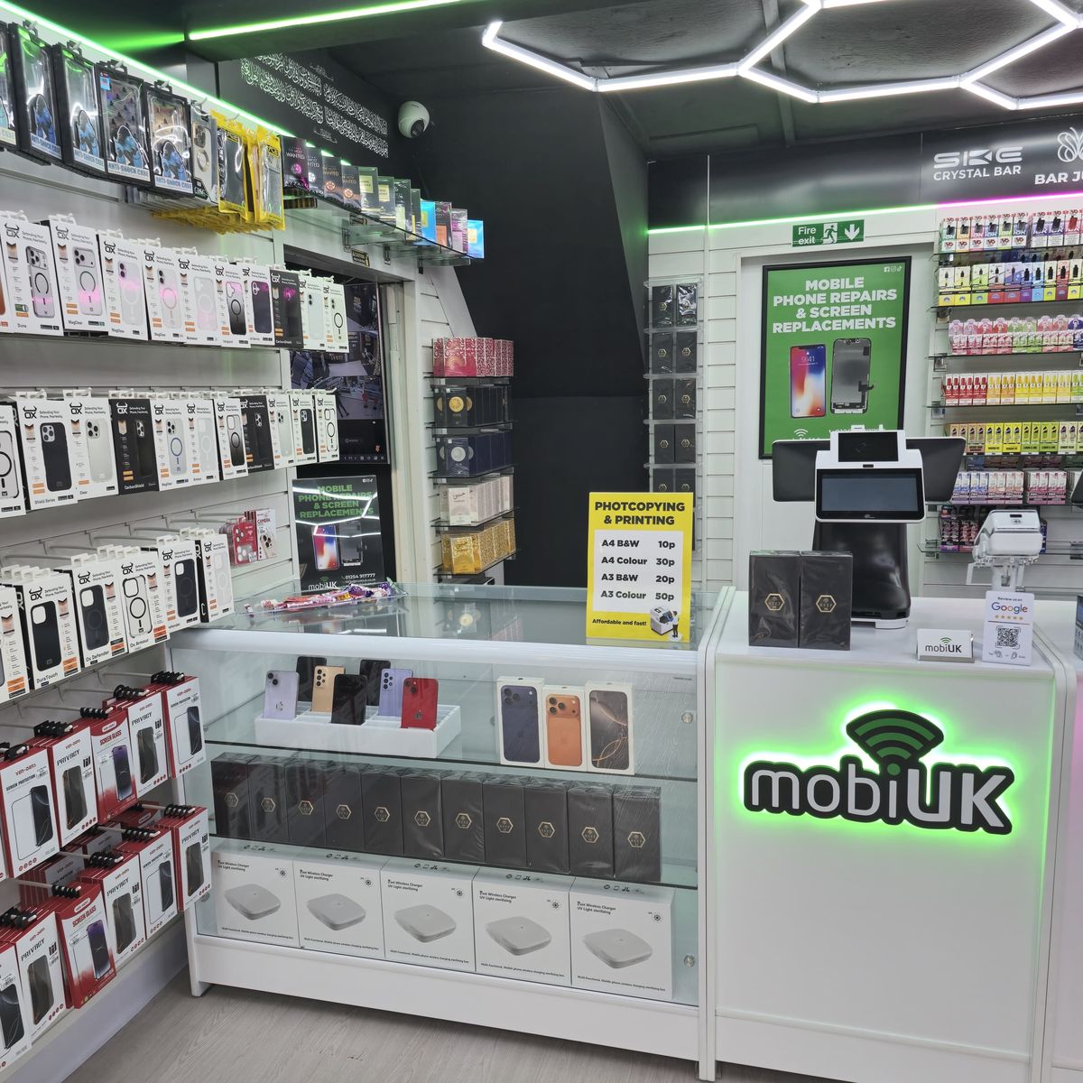 Wall of phone cases at mobiUK Accrington — Samsung and Apple cases on display